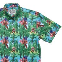 RSVLTS Smells Like Bigfoot’s Hot Dog KUNUFLEX Short Sleeve Shirt in Green — front view